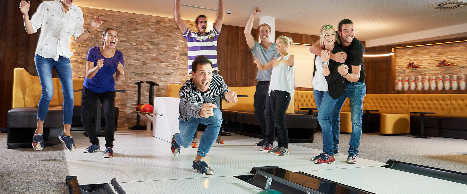 A group enjoys bowling at the Lürzerhof during their active vacation in Austria.