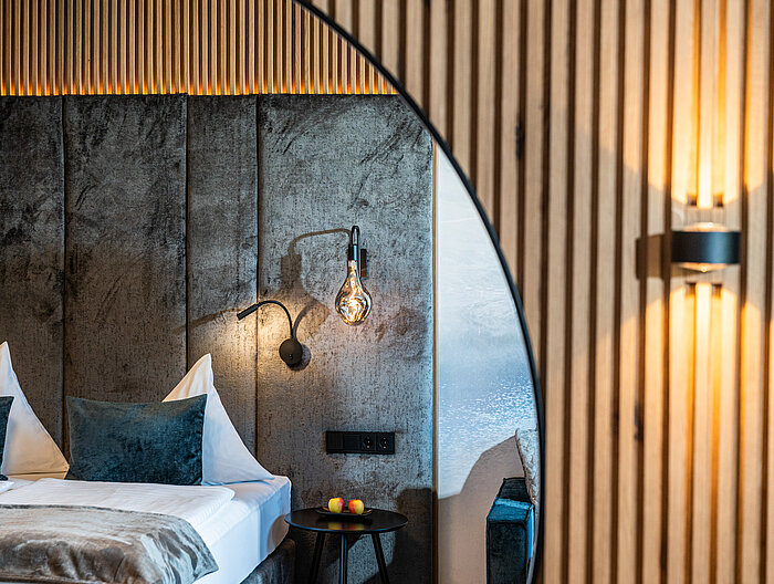 The cozy bed in the Mountain Loft Family Suite at the Lürzerhof
