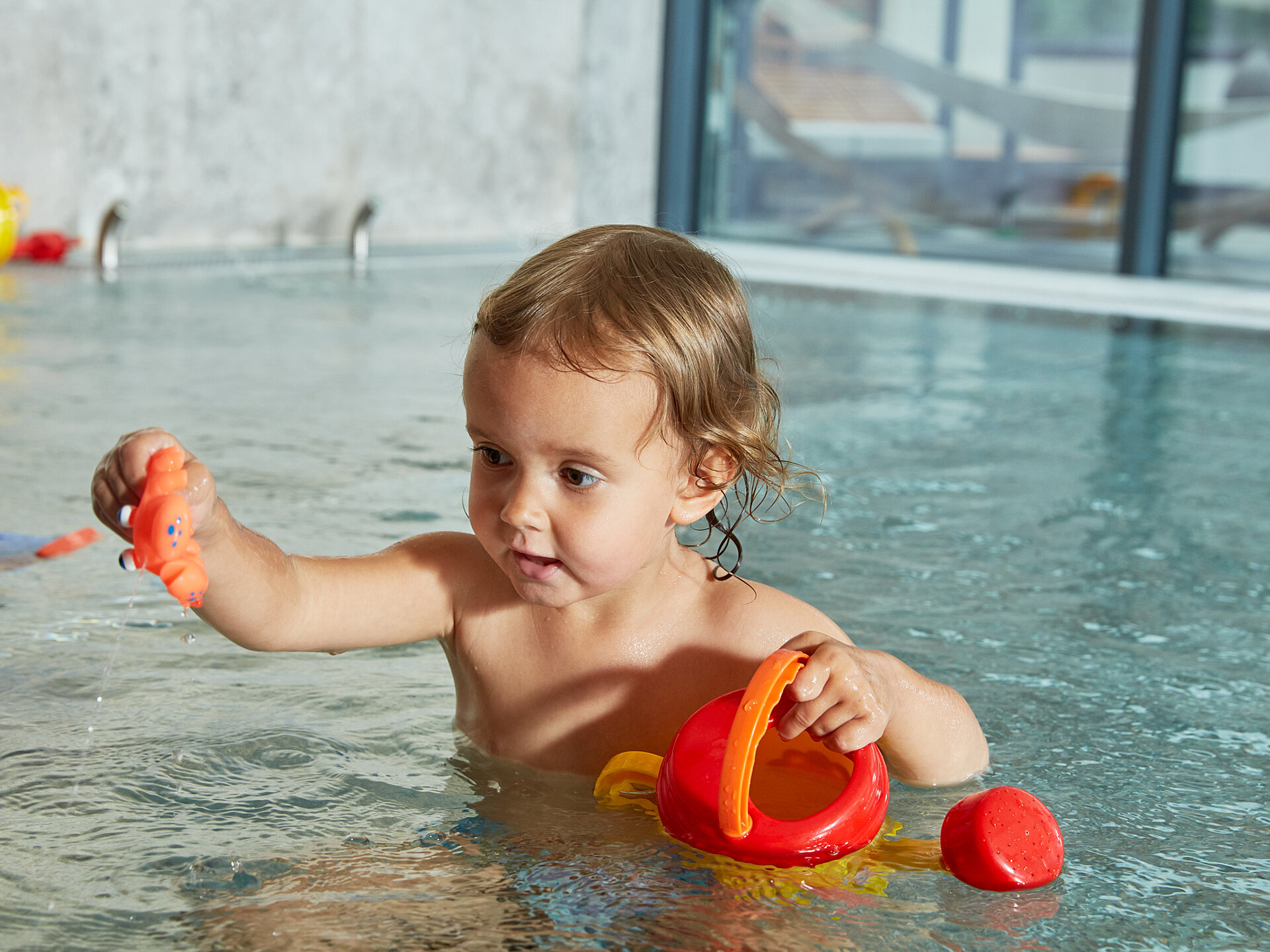 A toddler plays in the indoor pool at the Lürzerhof wellness hotel in Salzburg.