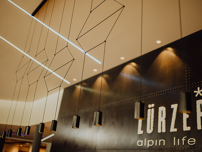 Stylish lamps at the reception desk of the Lürzerhof