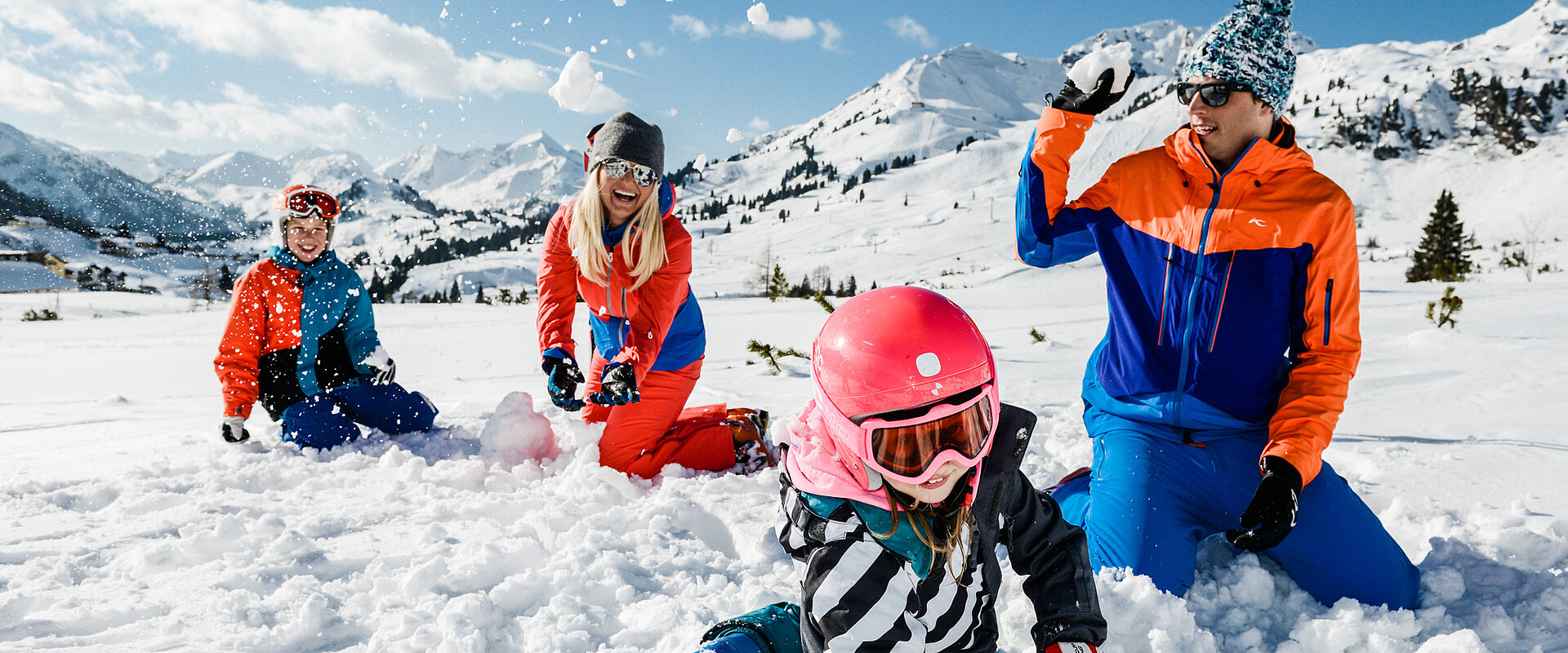 Family having fun in the snow on an active vacation in Austria