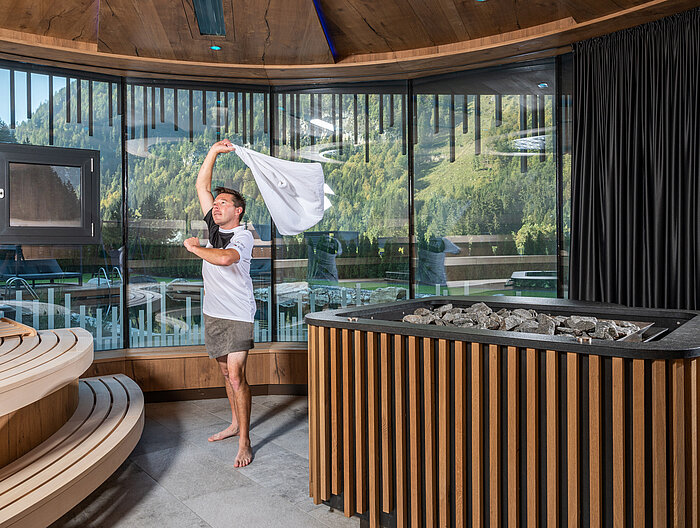 A man performs a sauna infusion at the Lürzerhof wellness hotel in Salzburg.