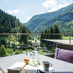 A woman enjoys the view of the Lürzerhof garden.