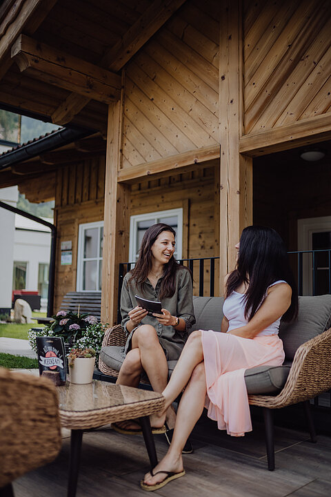 Two women look at the ice cream menu in the garden of the Lürzerhof.