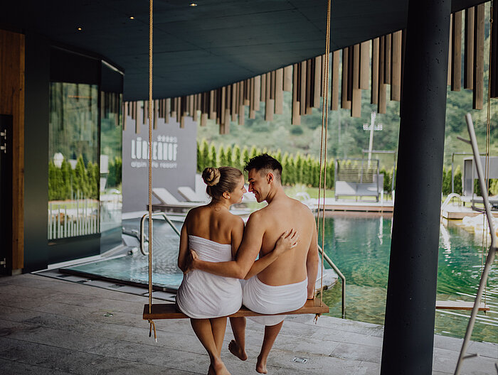 A couple relaxes on a swing at the Lürzerhof wellness hotel in Salzburg.