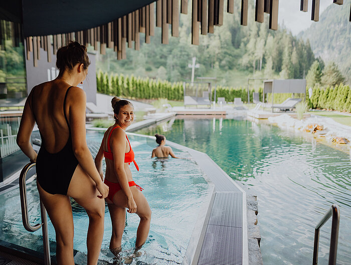 Guests enjoy the outdoor pool at the Lürzerhof wellness hotel in Salzburg.