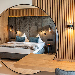 The cozy bed in the Mountain Loft Family Suite at the Lürzerhof