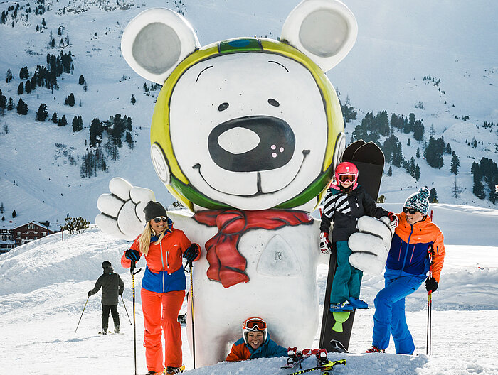 Family having fun in the snow on an active vacation in Austria